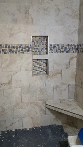 Had to use blue tape to cover these mosaic pieces because when grout gets into the crevices, it won't come out! I used Mapei's Flex color single component grout and it will look the same in 10 years as when I left. The other bid is cheaper because t…