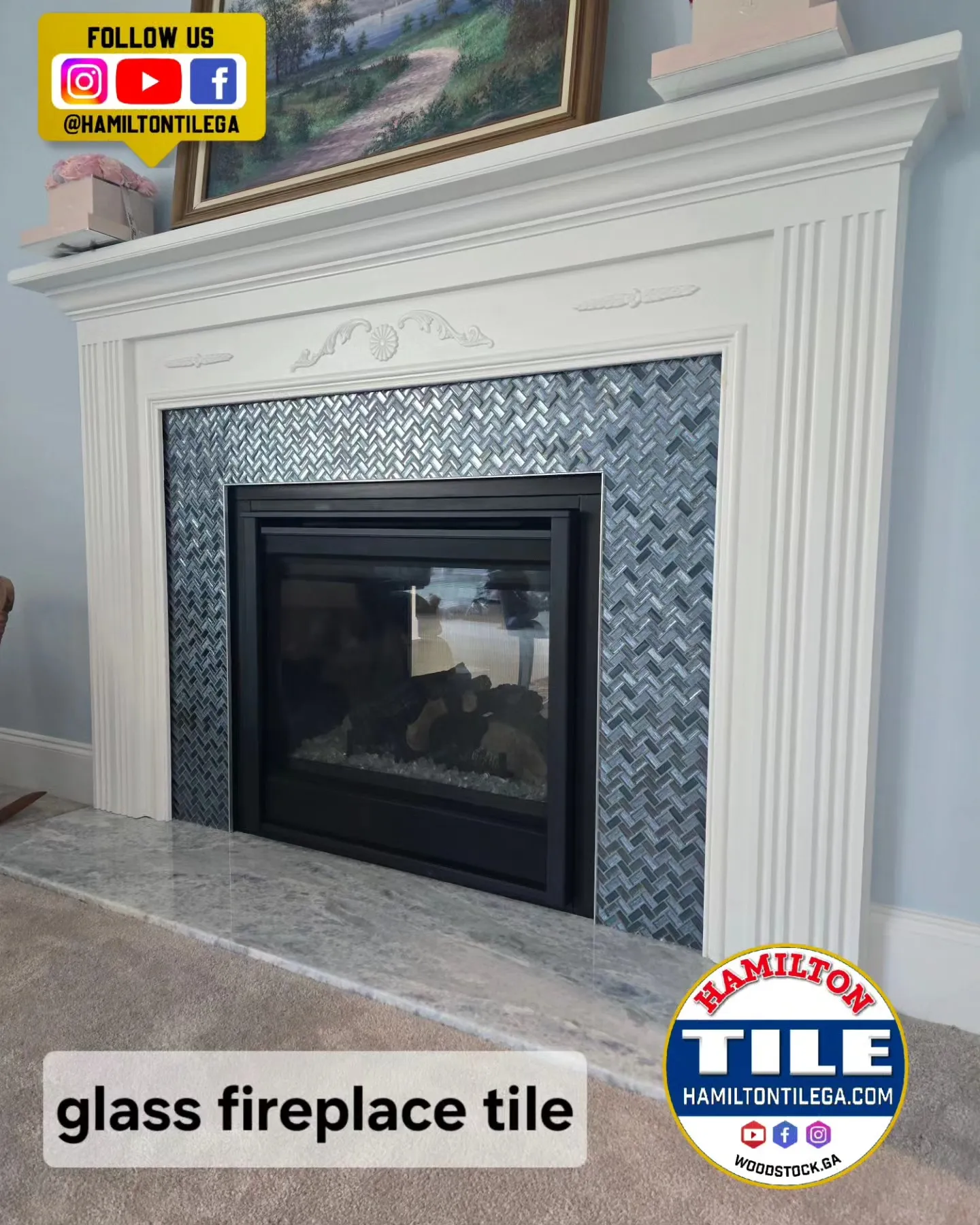 White mantel fireplace with blue glass tile surround and black insert, branded Hamilton Tile graphic overlays