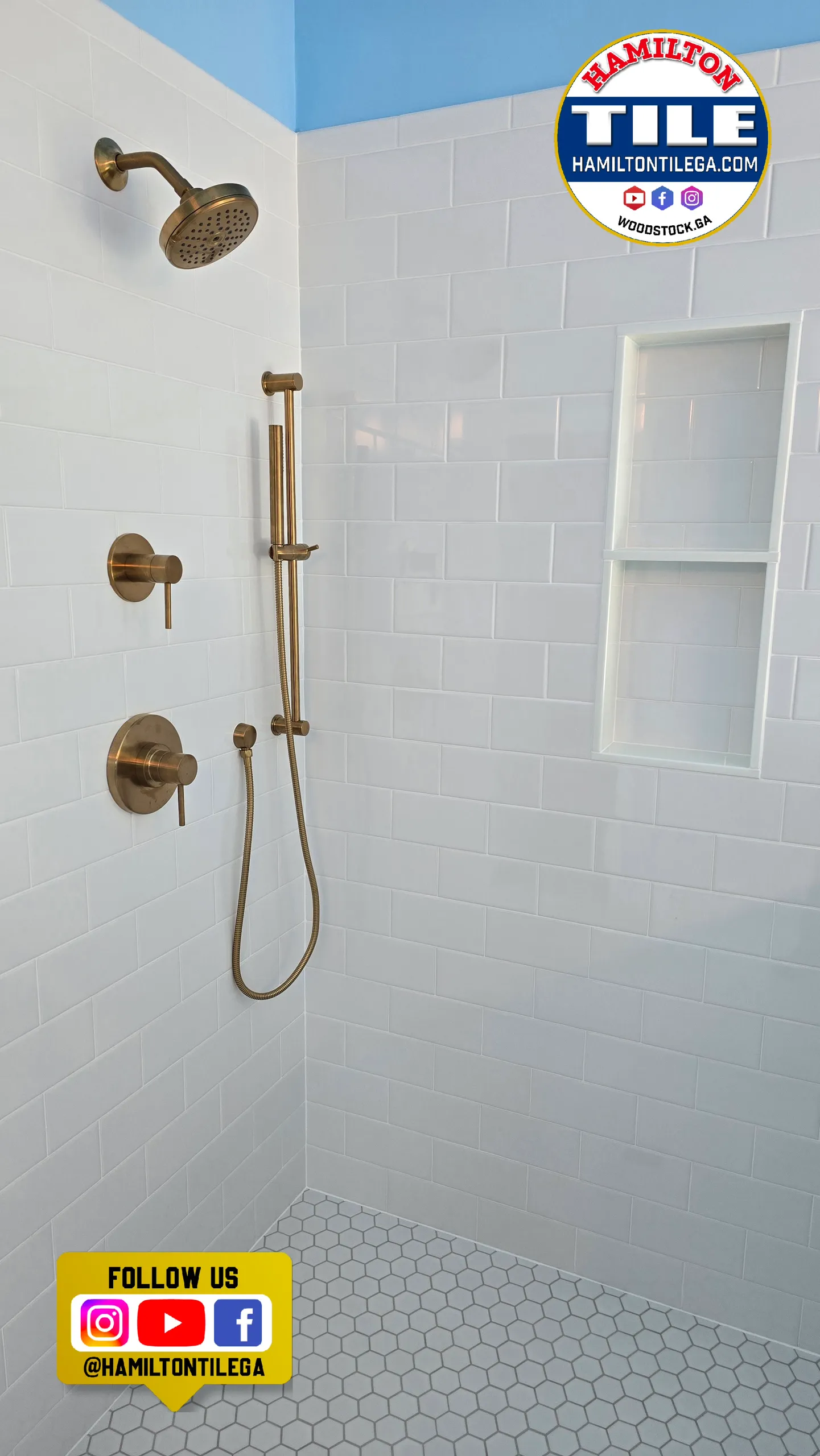 White subway-tile shower with brass fixtures, niche, and hexagonal floor tile in a renovated bathroom